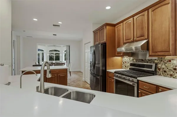 a spacious bathroom with double vanity sinks a toilet a shower a vanity and a mirror