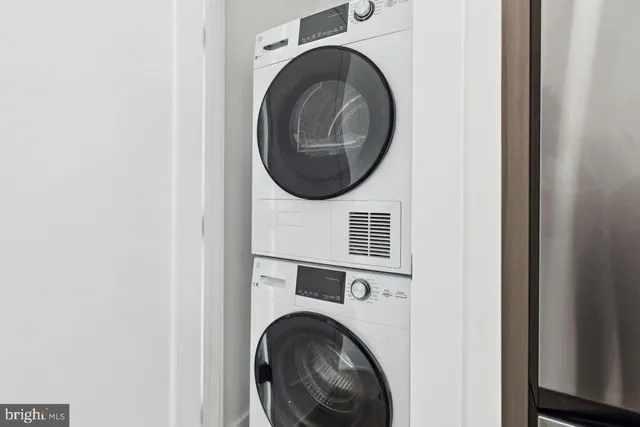 a close view of a utility room with dryer and washer