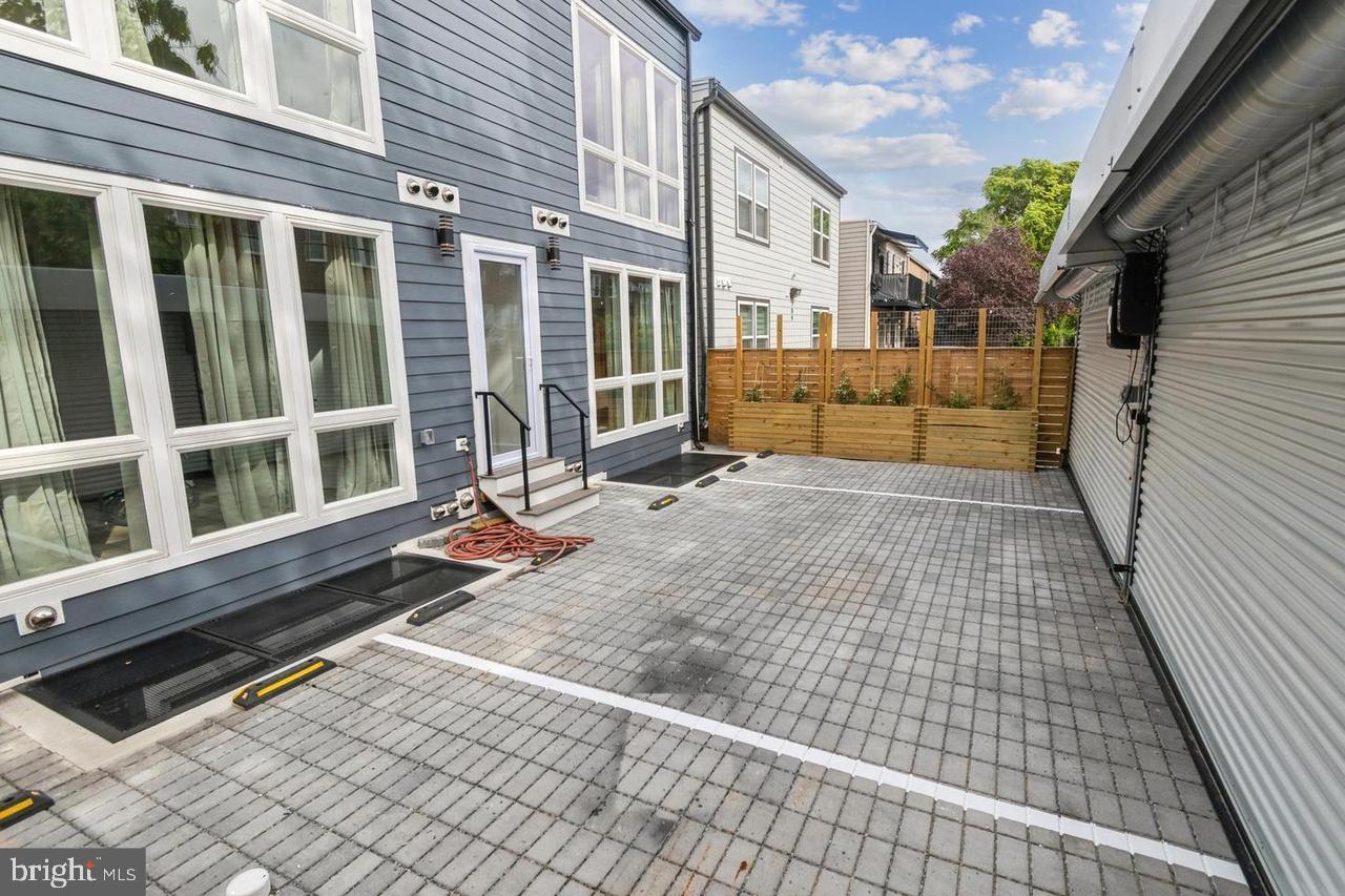 705 Quincy Street Northeast, Unit 4 Washington, DC 20017 - Photo 7 of 7 a view of a house with a large window and wooden fence