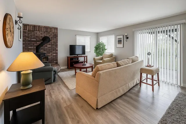 a living room with furniture a lamp and a window