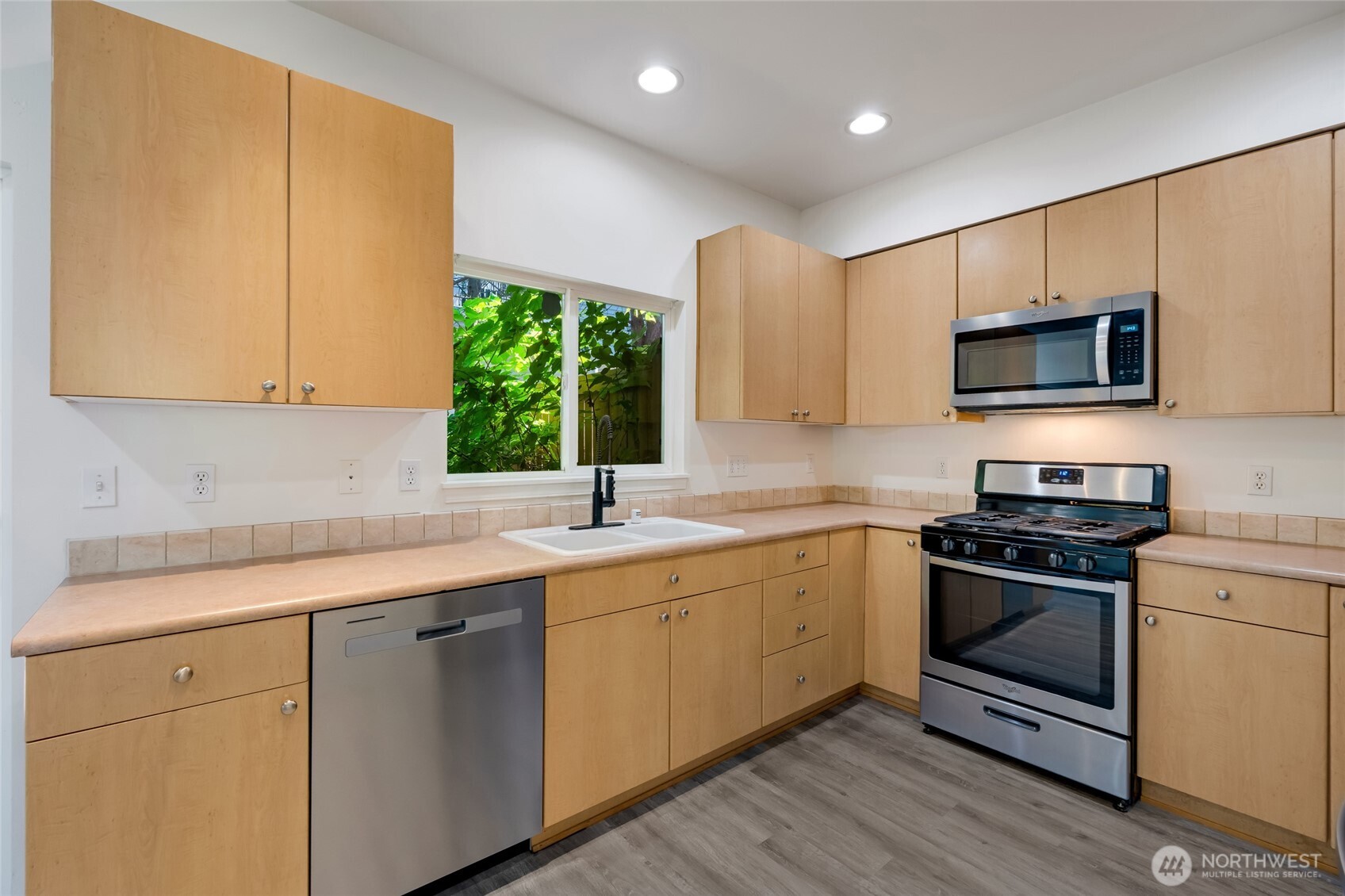 4740 Lake Place South, Unit A Renton, WA 98055 - Photo 12 of 24 a kitchen with a sink stove and microwave