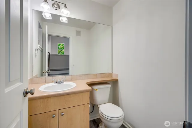 a bathroom with a sink a toilet and mirror