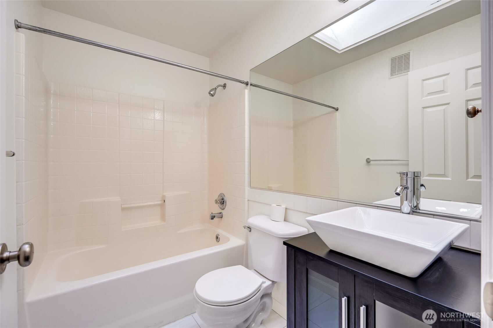 4740 Lake Place South, Unit A Renton, WA 98055 - Photo 17 of 24 a bathroom with a sink a toilet a mirror and a shower