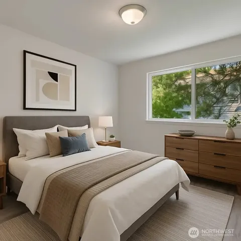 a bedroom with a bed and a large window