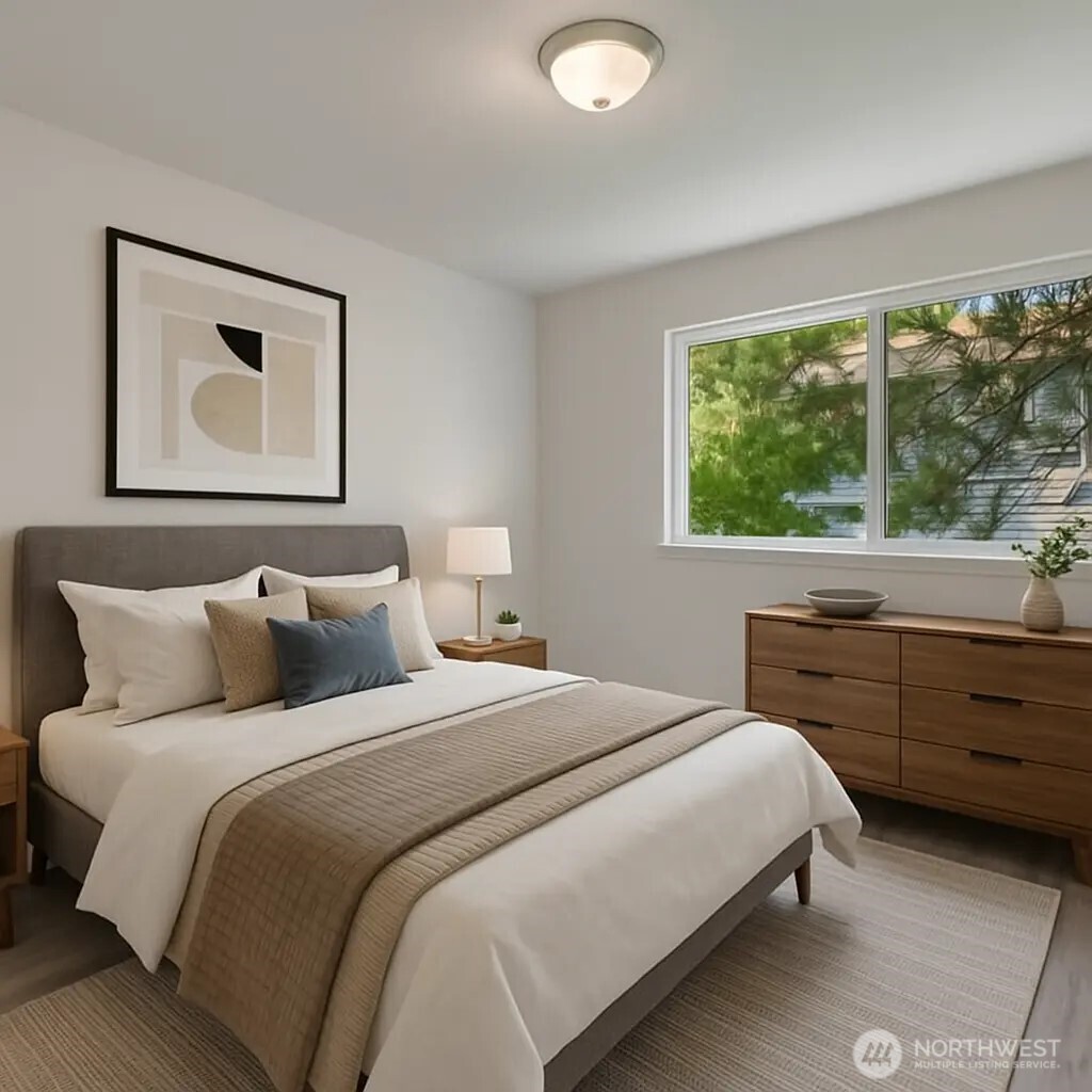 4740 Lake Place South, Unit A Renton, WA 98055 - Photo 18 of 24 a bedroom with a bed and a large window