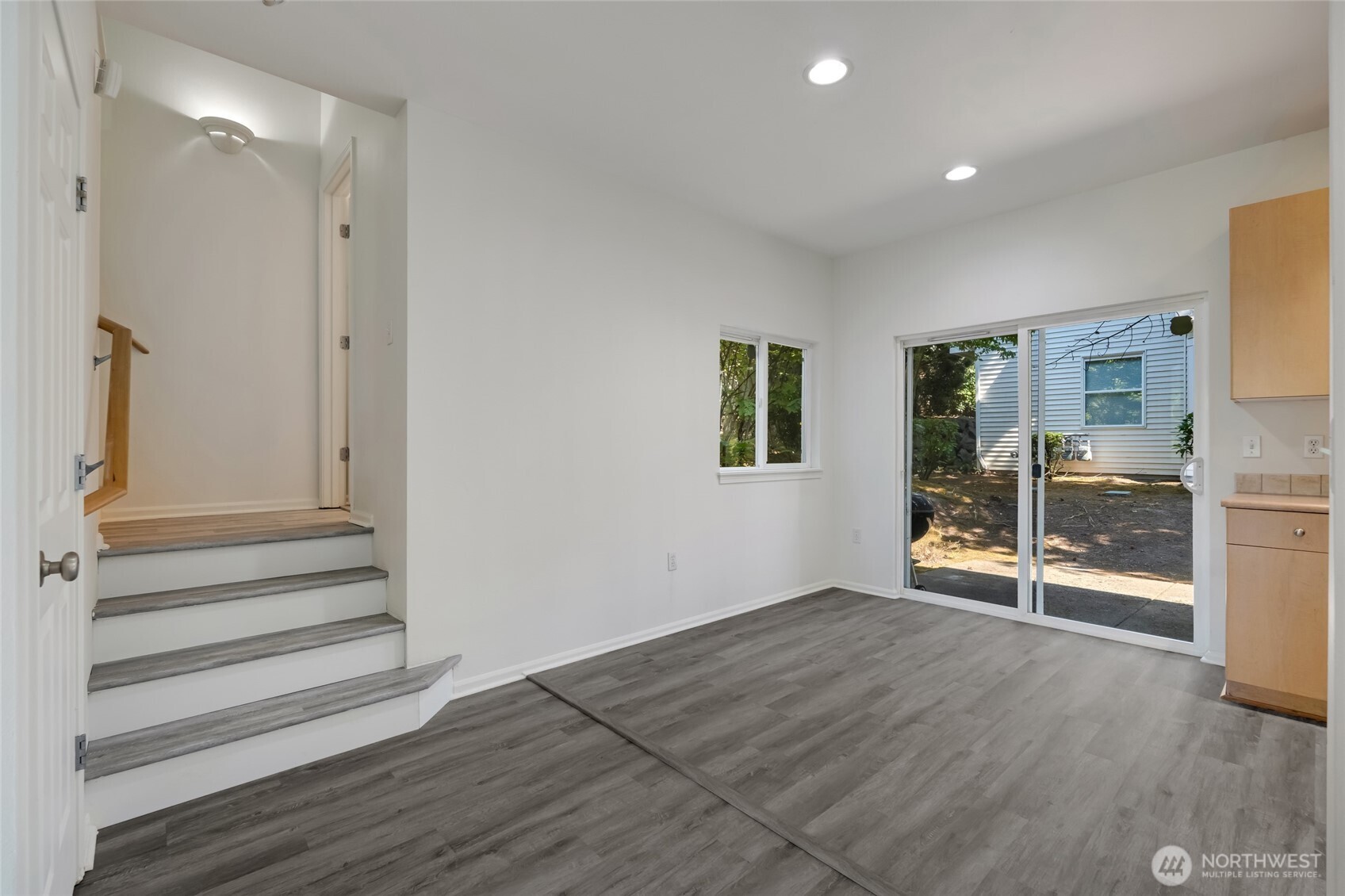 4740 Lake Place South, Unit A Renton, WA 98055 - Photo 9 of 24 a view of an empty room with wooden floor and a window