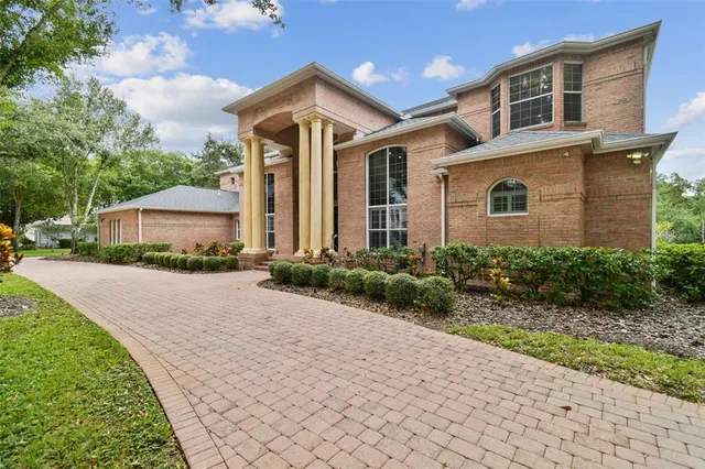 a front view of a house with a yard and trees