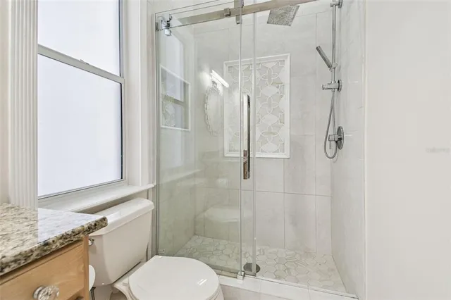 a kitchen with granite countertop a sink and cabinets