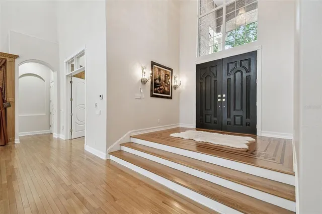 a view of an entryway with wooden floor and windows