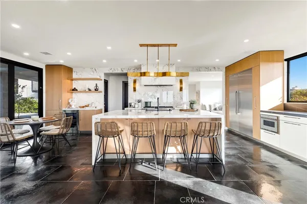 a view of a house with pool and sitting area