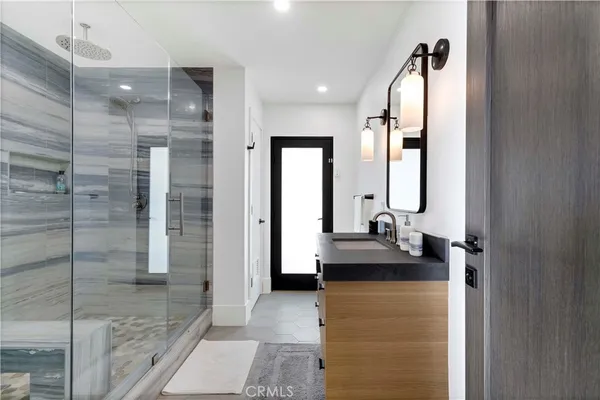 a bathroom with double vanity and a mirror