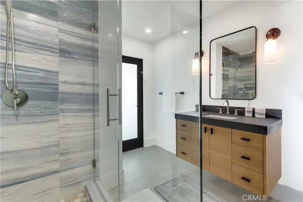 a bathroom with a double vanity sink mirror and shower