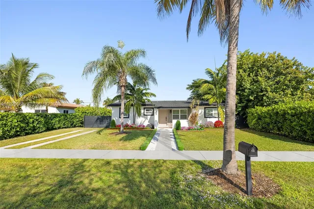a view of a house with swimming pool and sitting area