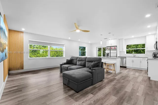 a living room with furniture and a large window