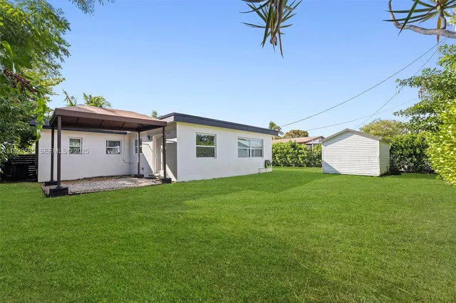 a view of a backyard with a garden and plants