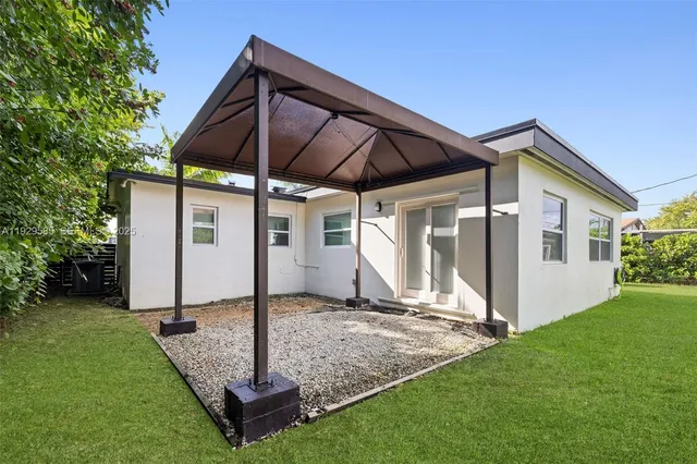 a front view of house with a garden