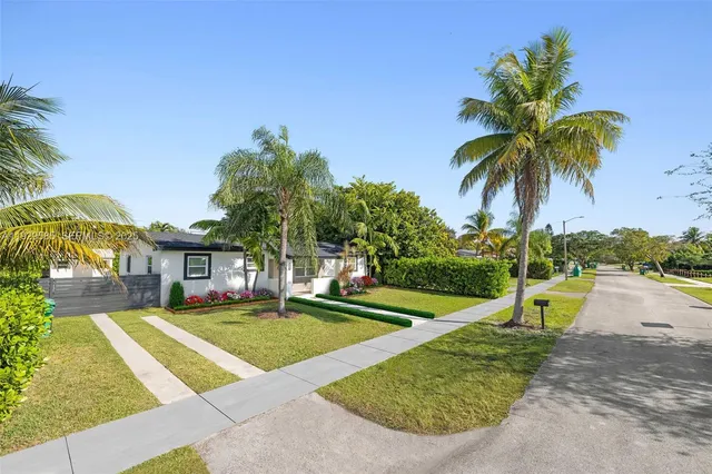 a front view of house with yard and green space
