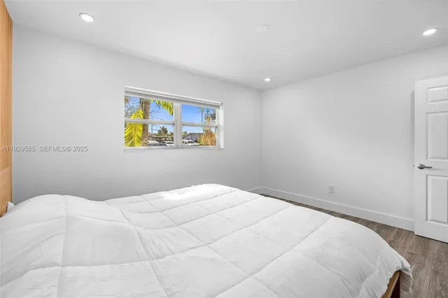 a bathroom with a granite countertop toilet a sink a mirror a bathtub and shower