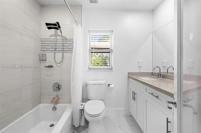 a bathroom with double sink and a mirror
