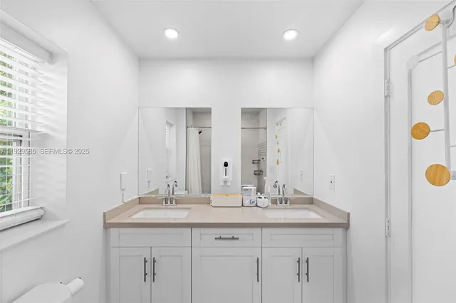 a view of a bedroom with baby crib and lounge chair