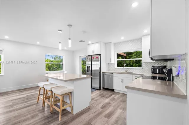 a large kitchen with a table and chairs in it