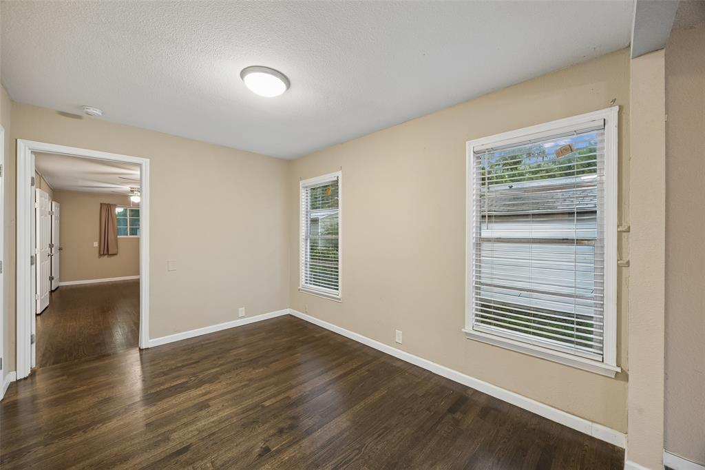 117 Moon Street Cleburne, TX 76033 - Photo 13 of 28 a view of an empty room with wooden floor and a window