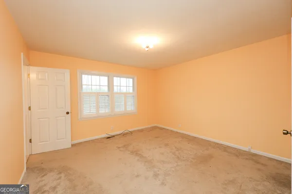 a view of room with walk in closet and window