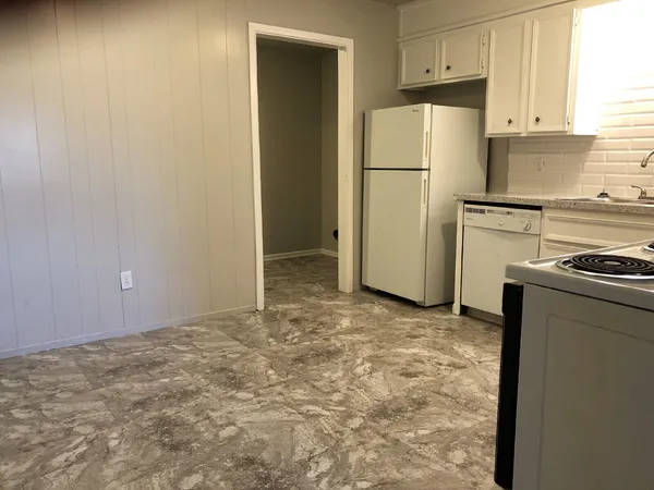 a view of a kitchen with refrigerator and cabinet
