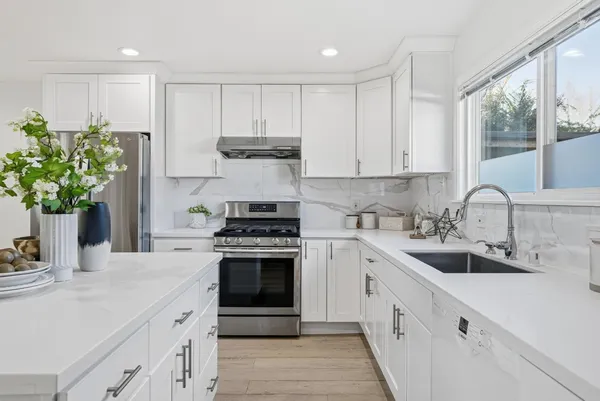 a kitchen with a sink stove and cabinets