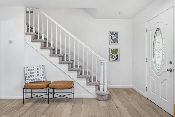 a view of staircase with wooden floor and a chandelier