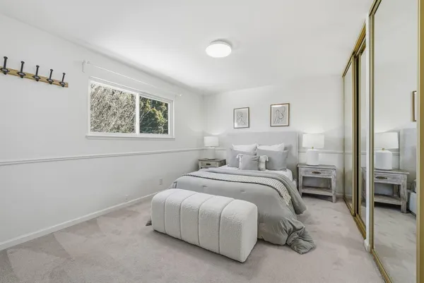 a bedroom with a bed and a painting on the wall