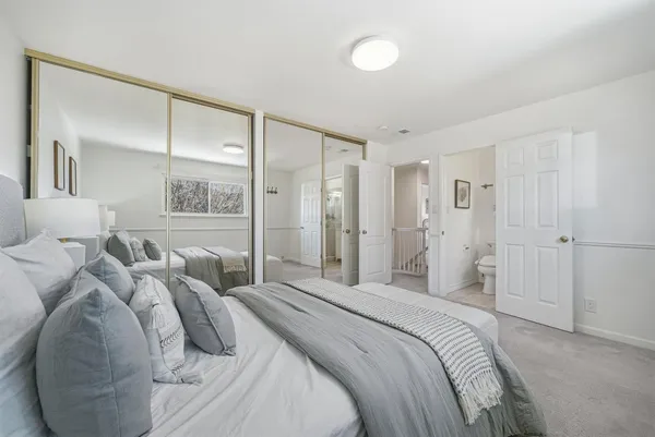 a bedroom with a bed and a mirror