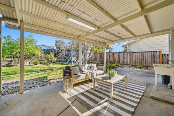 a view of a patio with a dining table and chairs with wooden floor