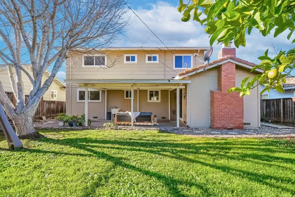 a front view of house with yard and outdoor seating