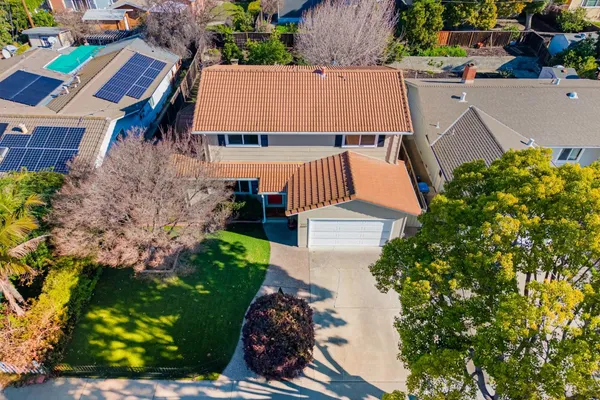 an aerial view of multiple houses with yard