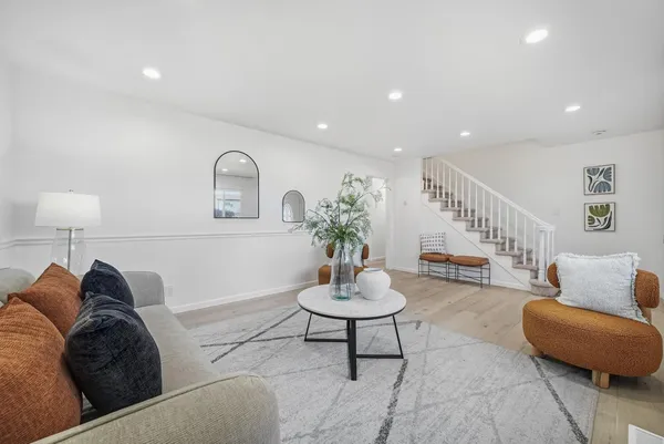 a living room with furniture and a potted plant