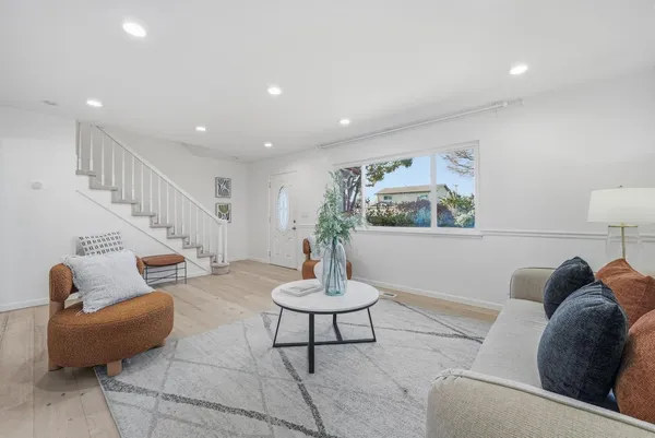 a living room with furniture and a potted plant