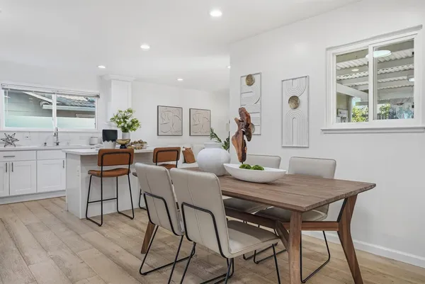 a view of a dining room with furniture and wooden floor