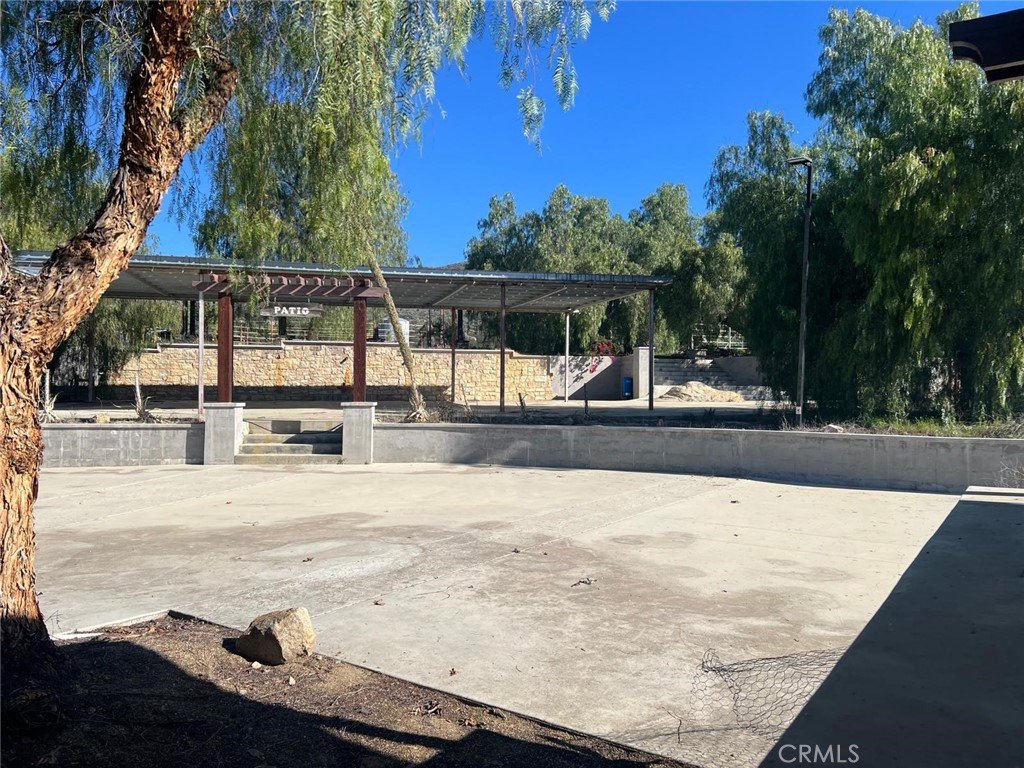 37220 Quarter Valley Road Temecula, CA 92592 - Photo 6 of 24 a view of a swimming pool with an outdoor space and seating area