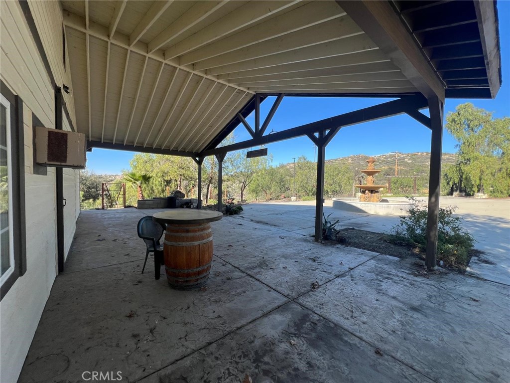 37220 Quarter Valley Road Temecula, CA 92592 - Photo 7 of 24 a view of a patio with table and chairs potted plants