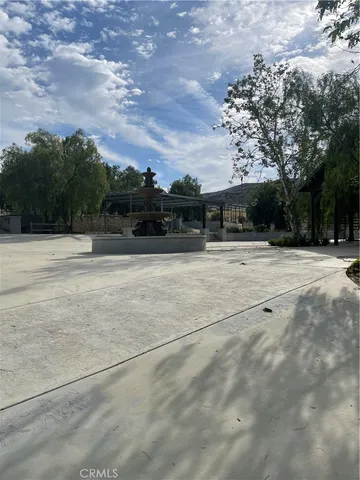 a view of outdoor space with swimming pool and trees