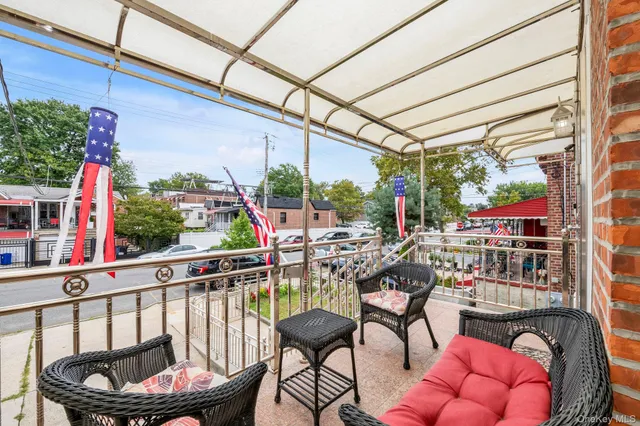 a view of a chairs and fire pit in the balcony
