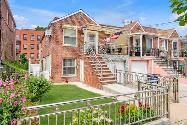 a front view of a house with plants