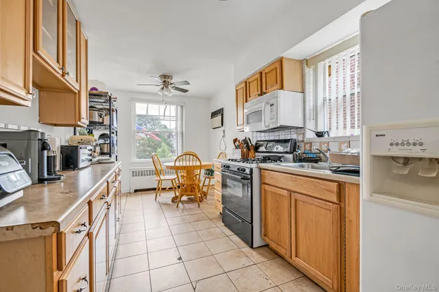 a kitchen with stainless steel appliances a stove sink refrigerator and cabinets