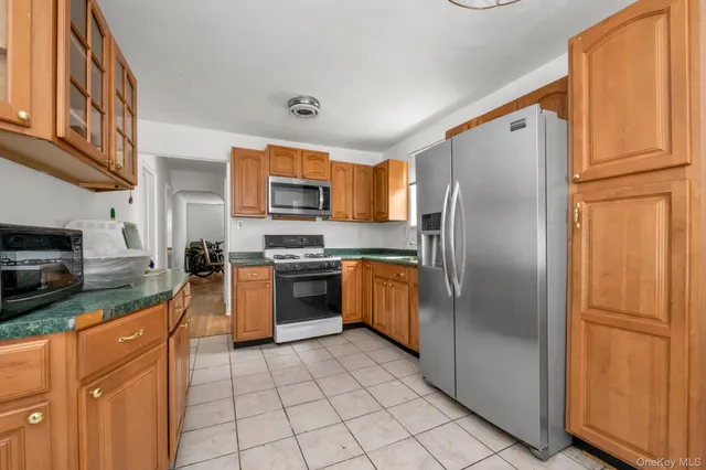 a kitchen with stainless steel appliances granite countertop a refrigerator stove and a sink