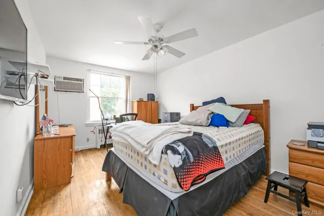 a bedroom with bed and window
