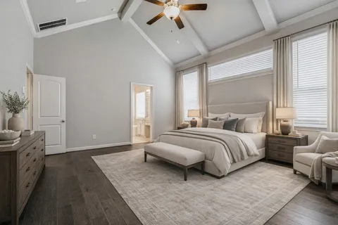 a spacious bedroom with a bed a couch and a ceiling fan