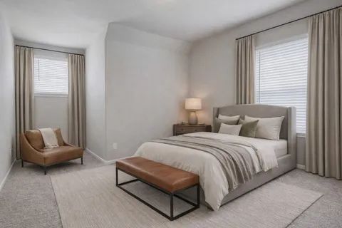 a spacious bedroom with a bed and a couch