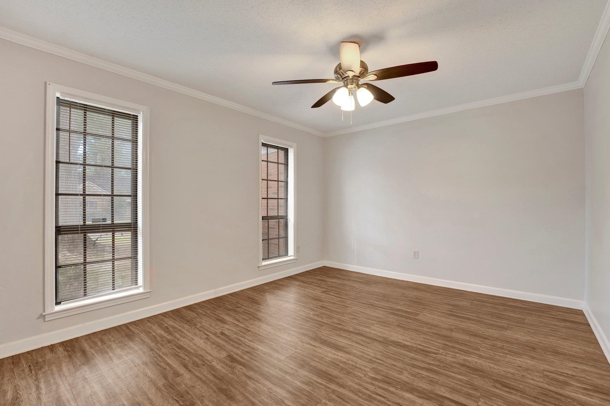 4988 Ridge Tree Drive Memphis, TN 38128 - Photo 4 of 22 a view of an empty room with wooden floor and a window