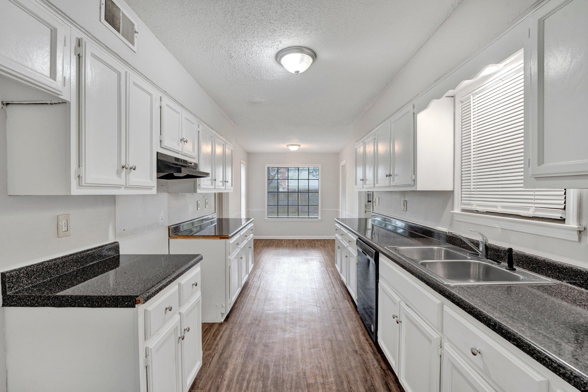 4988 Ridge Tree Drive Memphis, TN 38128 - Photo 7 of 22 a kitchen with granite countertop a sink a counter space cabinets and stainless steel appliances
